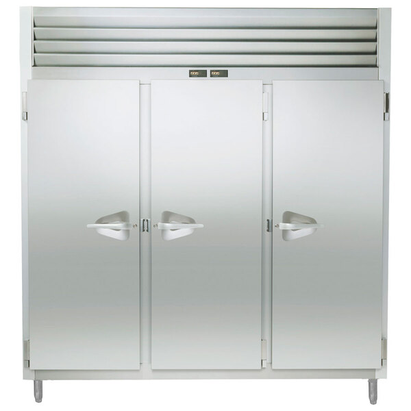 A Traulsen stainless steel reach in refrigerator / freezer with three doors open.