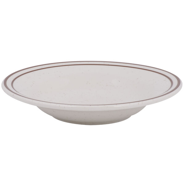 A white soup bowl with a brown speckled rim.