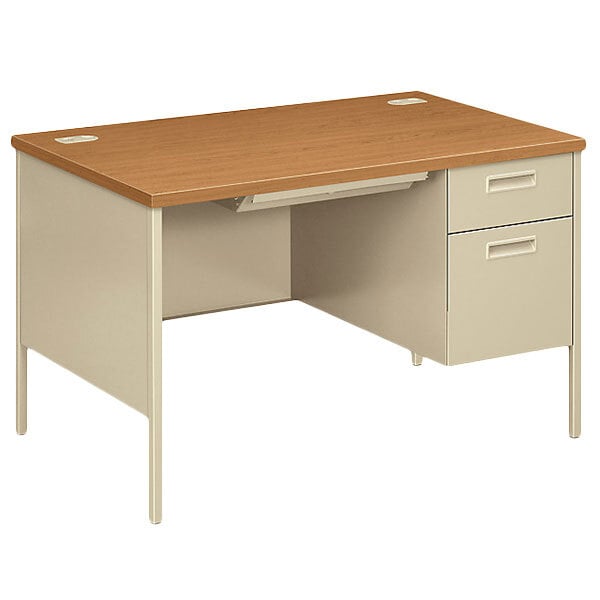 A HON Metro Classic pedestal desk in harvest and putty with a light brown top and two drawers.