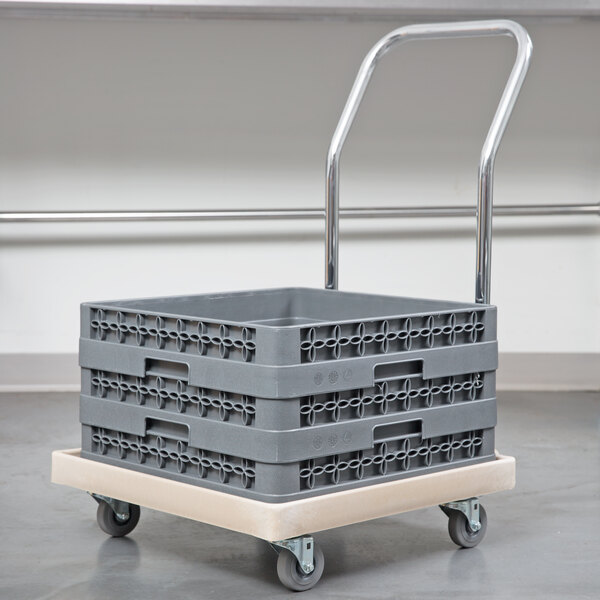 A beige Vollrath dish rack dolly with a chrome-plated handle and swivel casters.