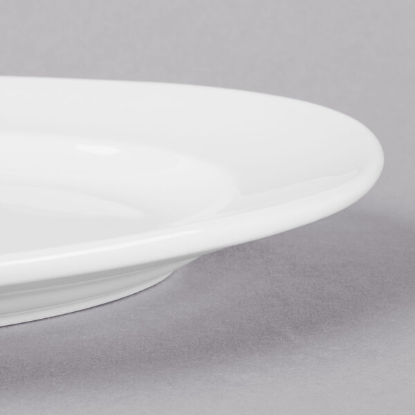 A close up of a Libbey Bright White oval porcelain platter with a rim.