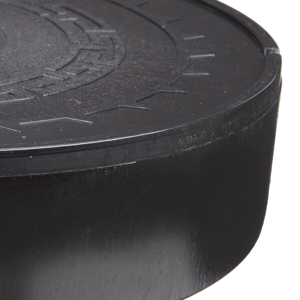 A close up of a black Carlisle microwaveable plastic tortilla server with a circular pattern.