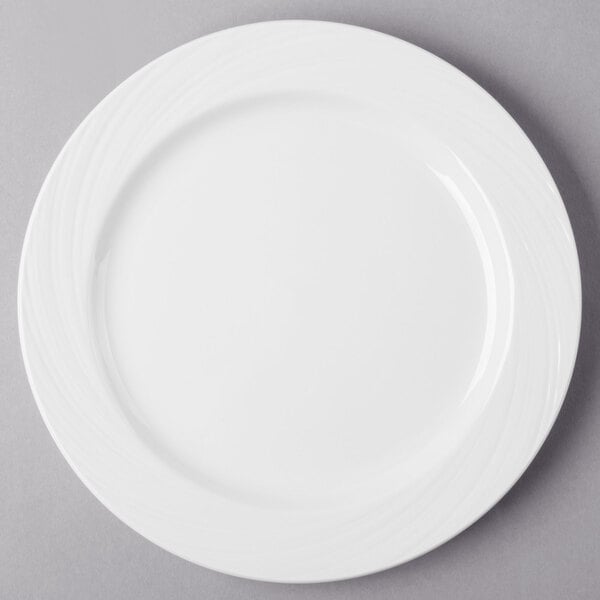 A Libbey bright white porcelain plate with a wavy design on the rim.