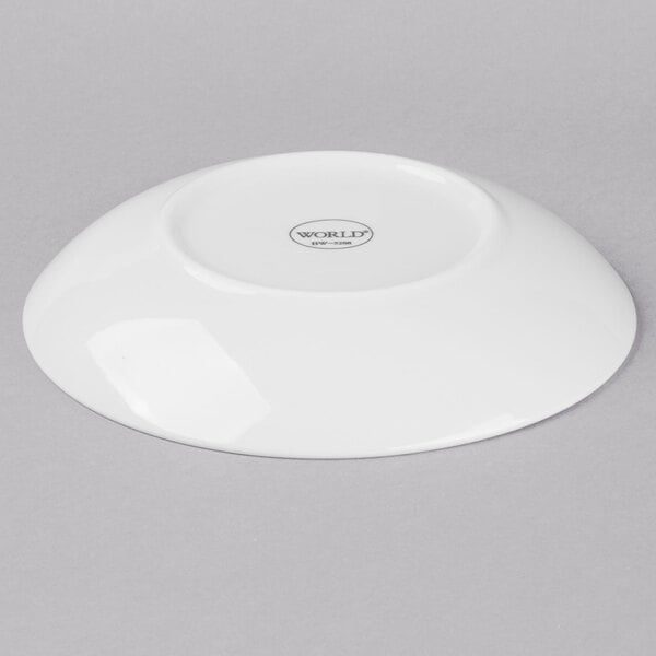 A Libbey bright white porcelain coupe plate with a small hole in the middle.