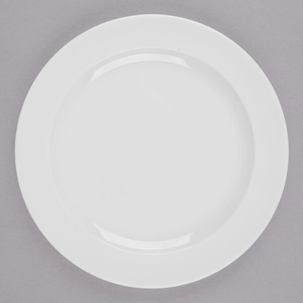 A Libbey bright white porcelain plate with a white rim on a gray surface.