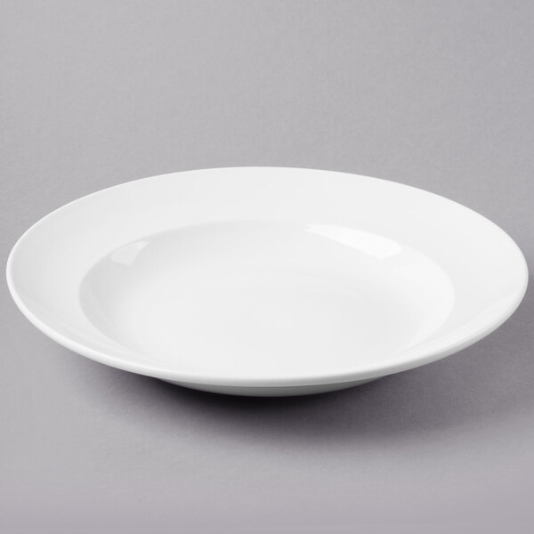 A Libbey bright white porcelain entree/pasta bowl on a white surface.