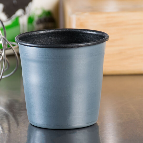 A small grey non-stick Matfer Bourgeat dariole mold on a counter.