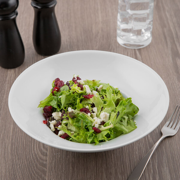 A bowl of salad with a fork.