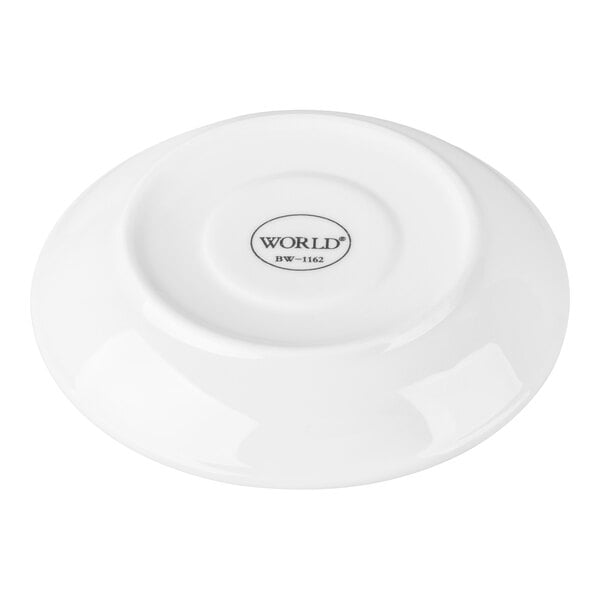 A white porcelain saucer with a small circular indentation in the center and the brand name 'WORLD' printed on the bottom.