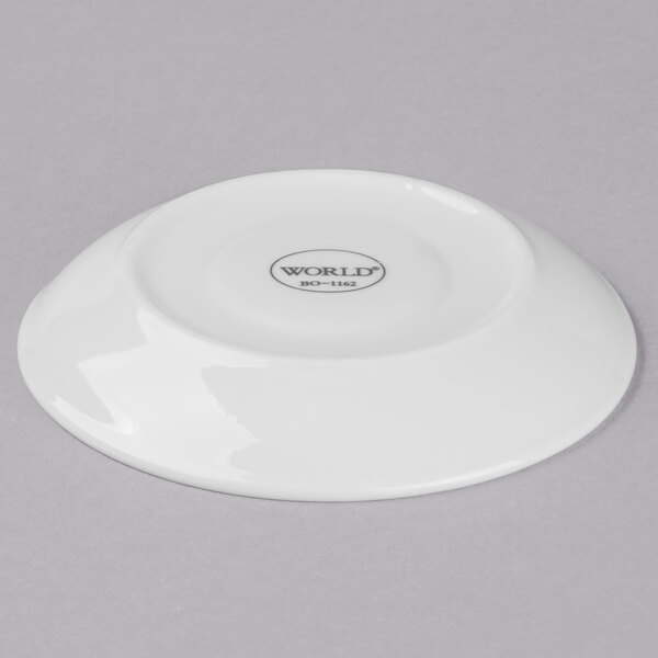 A white Libbey porcelain saucer with a small white circle in the center.