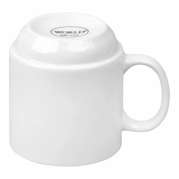 A plain white porcelain stacking mug shown upside down with a handle.