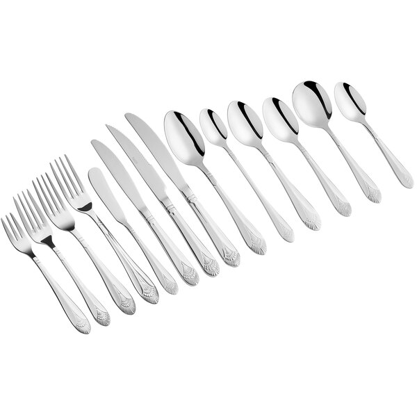 A row of Acopa Monaca stainless steel table forks.