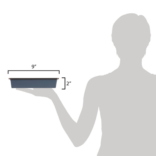 A person holding a rectangular tray with a Matfer Bourgeat square cake pan in it.