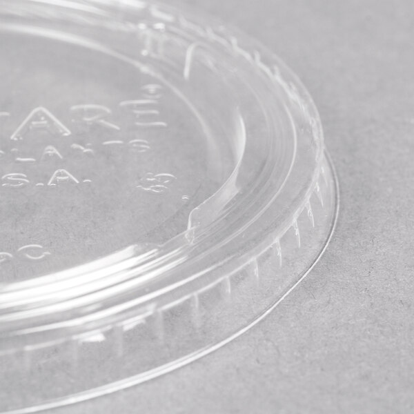 A close-up of a Fabri-Kal clear plastic portion cup lid.