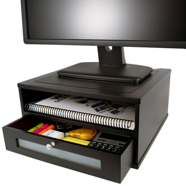 A Victor wood monitor riser with a drawer.