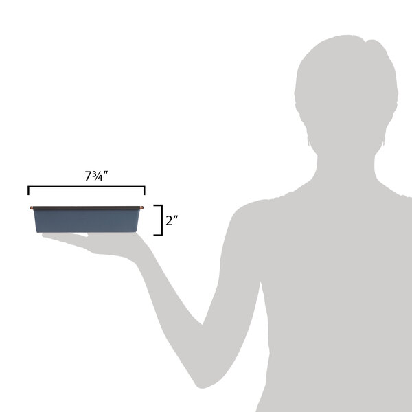 A woman using a Matfer Bourgeat square cake pan on a counter.