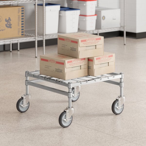 A Regency heavy-duty chrome dunnage rack with a mat on it holding boxes.