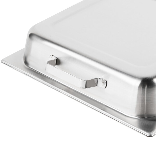 A Vollrath stainless steel hinged dome lid on a metal tray.