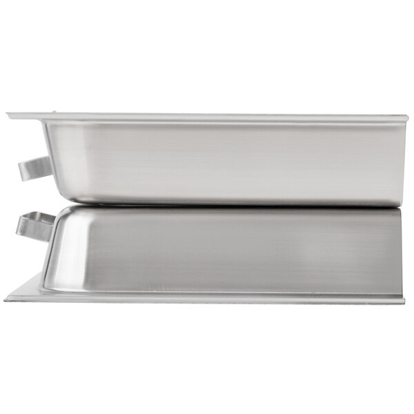 A Vollrath stainless steel hinged dome with handles on a white rectangular tray.