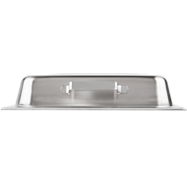 A Vollrath stainless steel hinged dome cover with a handle on a silver tray.