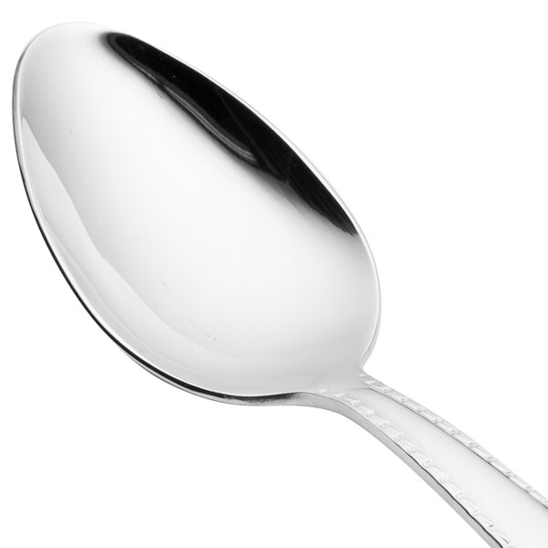 A close-up of a Reed & Barton stainless steel dessert spoon with a black and white handle.
