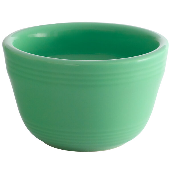 A green Tuxton China bouillon cup with a handle.