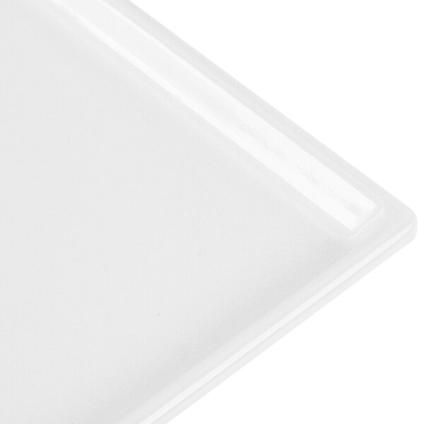 A close-up of a white Tablecraft rectangular cast aluminum cooling platter.
