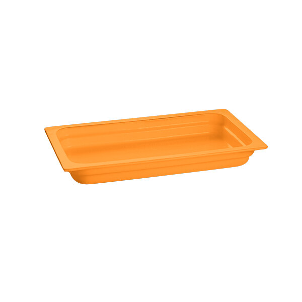 An orange rectangular cast aluminum food pan on a counter.