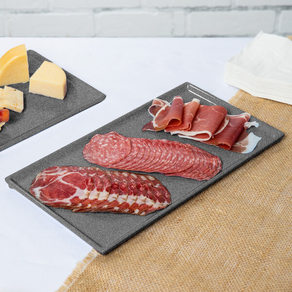 A Tablecraft granite cast aluminum rectangular cooling platter with meat and cheese.