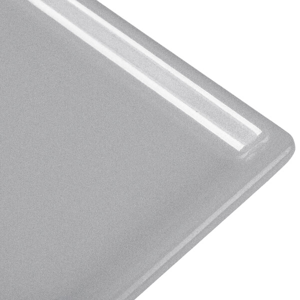 A natural cast aluminum rectangular cooling platter with a silver edge.