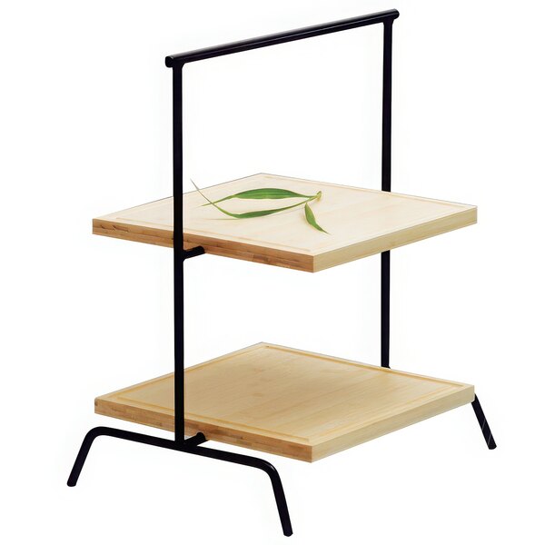 A Clipper Mill 3-tier black iron riser with leaves on the shelves.