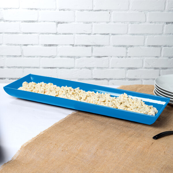 A sky blue rectangular Tablecraft tray with food in it.