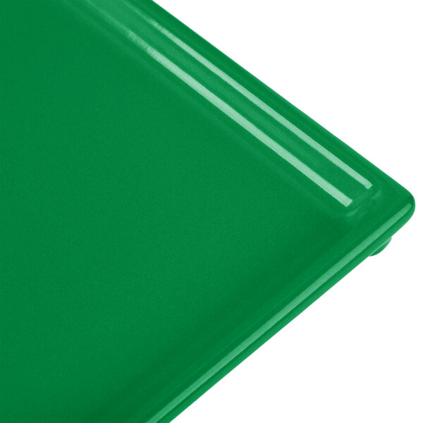 A close-up of a green Tablecraft rectangular cast aluminum cooling platter.