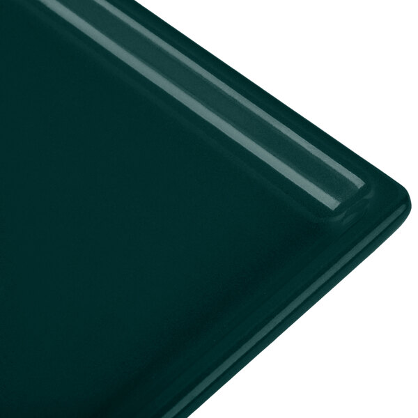 A rectangular dark green Tablecraft cast aluminum cooling platter.