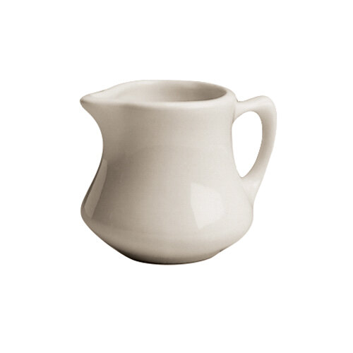 A Hall China ivory creamer with a handle.