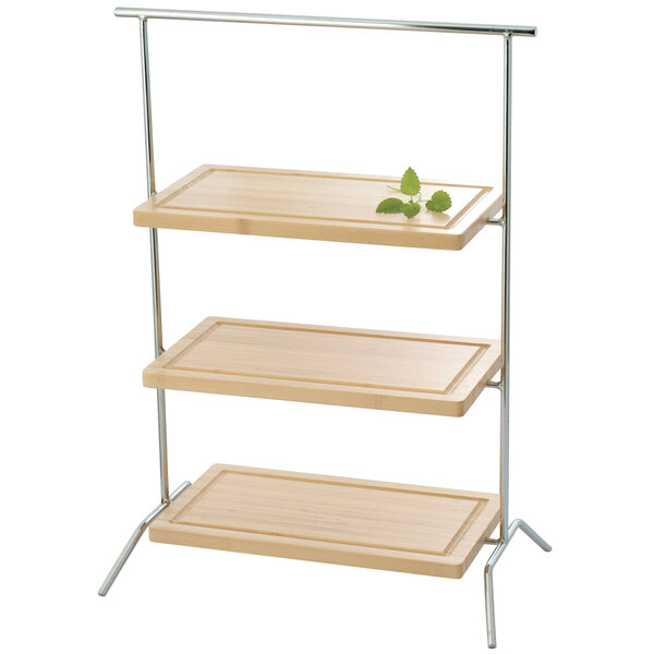 A three tiered Clipper Mill rectangular riser with a green leaf on it.