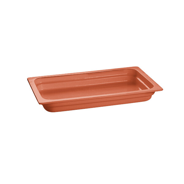 A copper rectangular cast aluminum food pan on a counter.