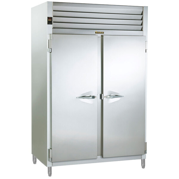 A white Traulsen reach in heated holding cabinet with solid doors.