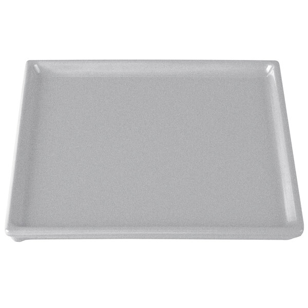 A natural cast aluminum rectangular cooling platter with a white border.