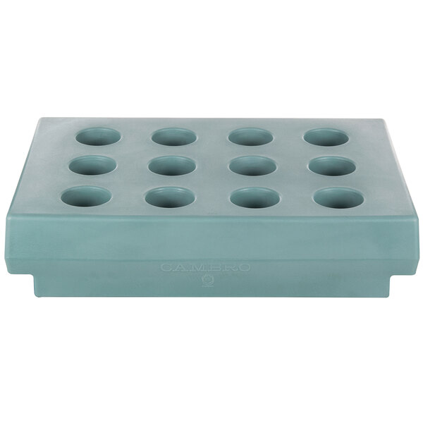 A rectangular slate blue tray with eight holes.