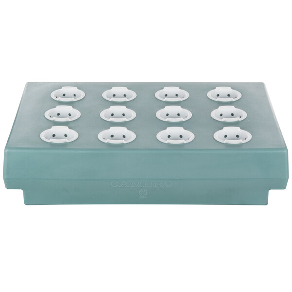 A rectangular slate blue plastic rack with white cutlery holes.