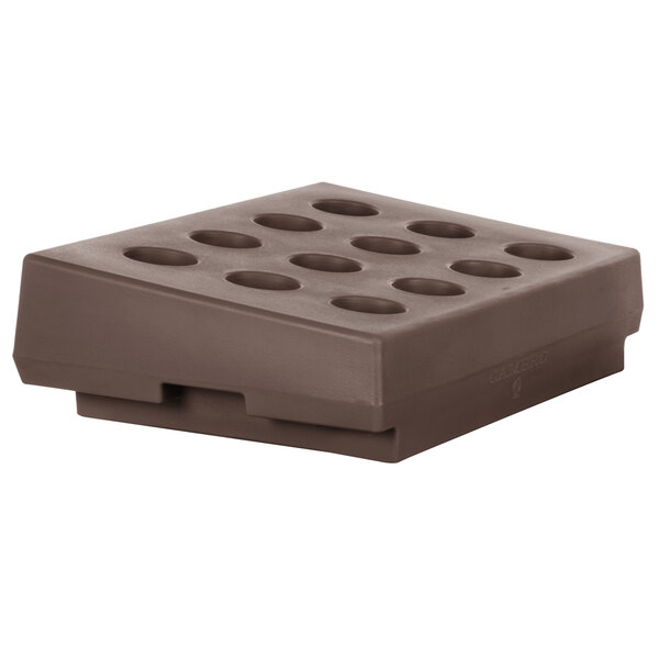 A dark brown plastic Cambro cutlery rack with holes.