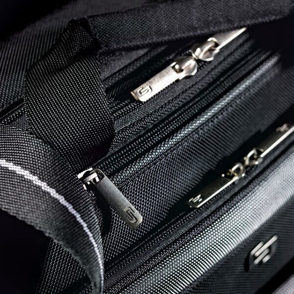A close-up of a black Solo Pro CheckFast briefcase with zippers.