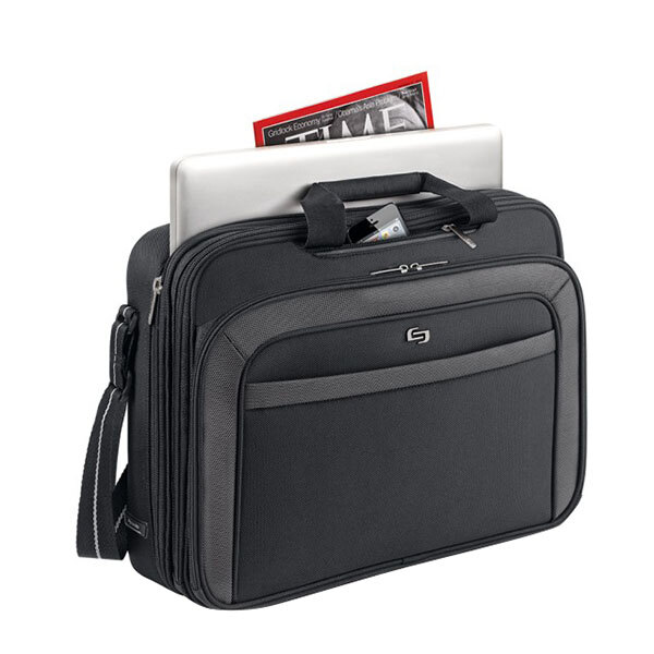 A Solo black laptop bag with a laptop, magazine, and a handle.