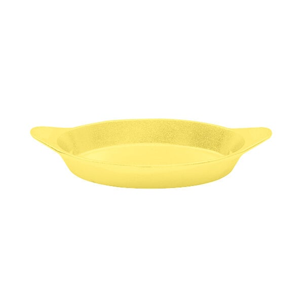 A yellow cast aluminum pan with shell handles.