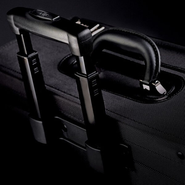 A close-up of a Solo black rolling catalog case with a handle.