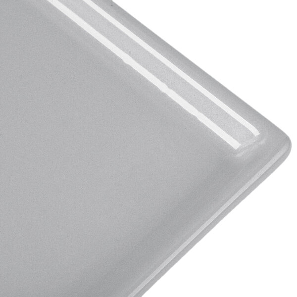 A natural cast aluminum rectangular cooling platter on a white surface.