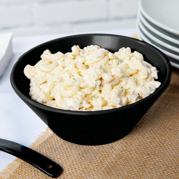 A Tablecraft black and green speckled cast aluminum serving bowl filled with macaroni salad.