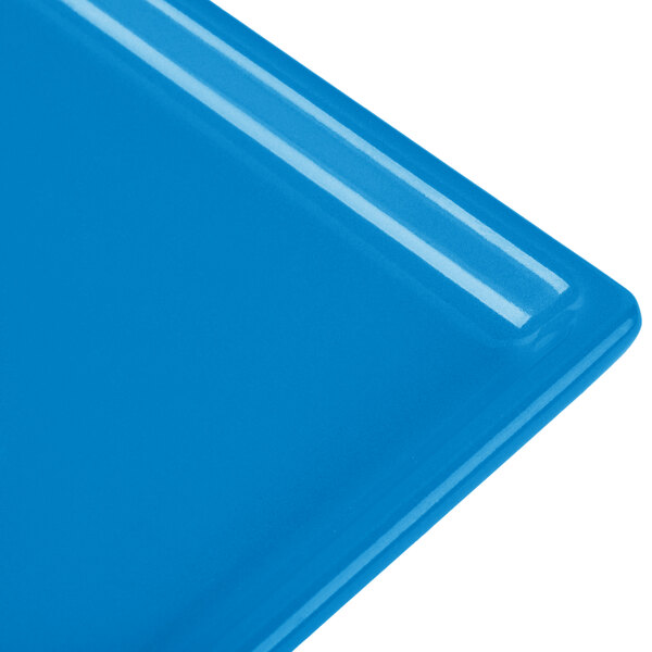 A close-up of a blue rectangular Tablecraft cast aluminum cooling platter.