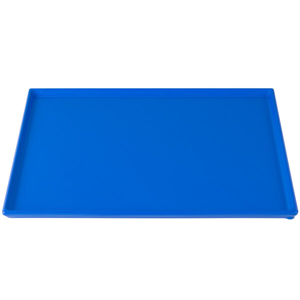 A cobalt blue rectangular cast aluminum tray on a table.